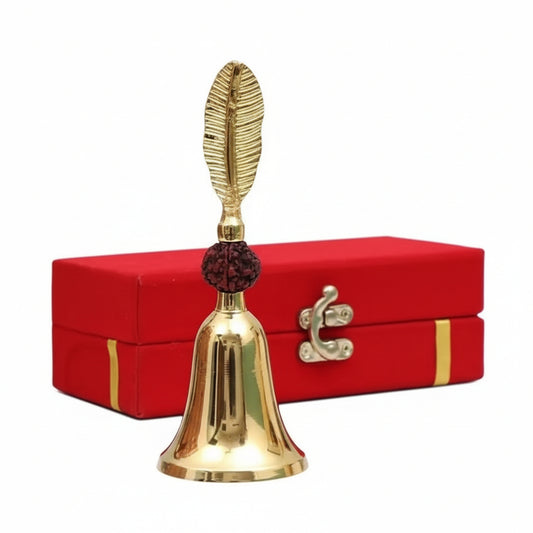Gold bell with decorative top on a red box against a gray background