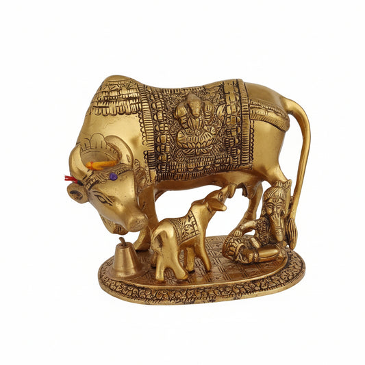 Decorative gold bull sculpture with intricate designs on a white background