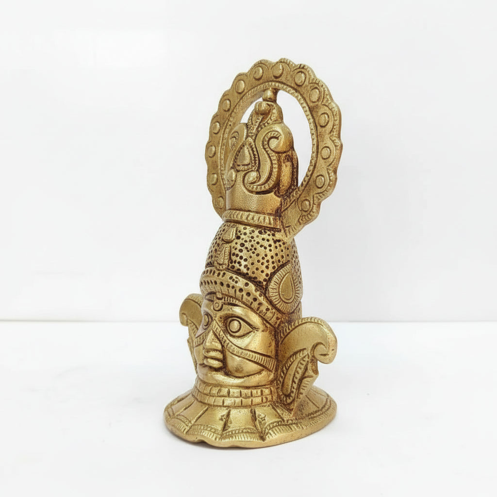 Gold-colored decorative statue with intricate design on a white background