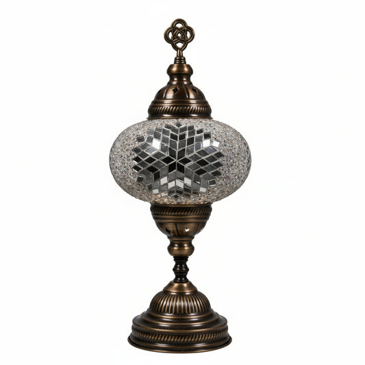 Decorative lamp with mosaic glass shade and bronze base on a white background