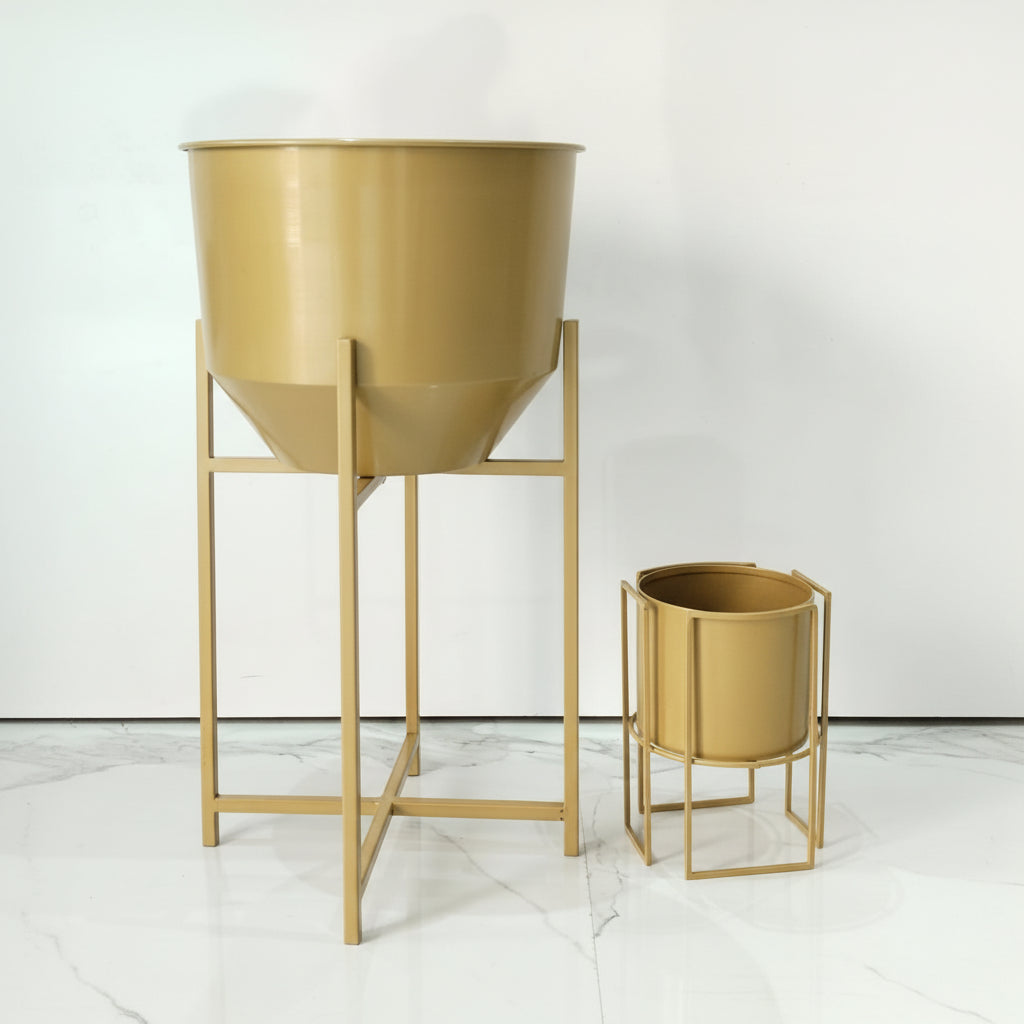 Gold metal planters on stands against a white background