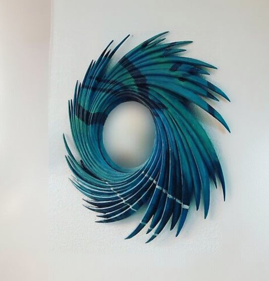 Decorative wall art with blue and black feather-like design on a white background