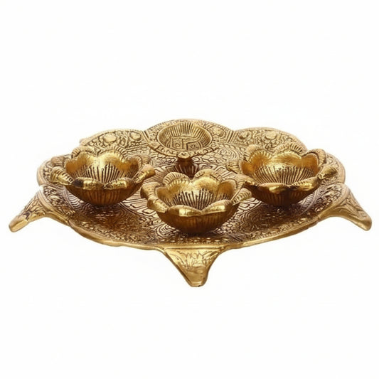 Decorative gold tray with floral designs on a white background