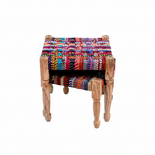 Colorful woven stool with wooden legs on a white background