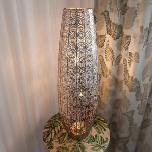 Decorative lamp with intricate pattern on a neutral background