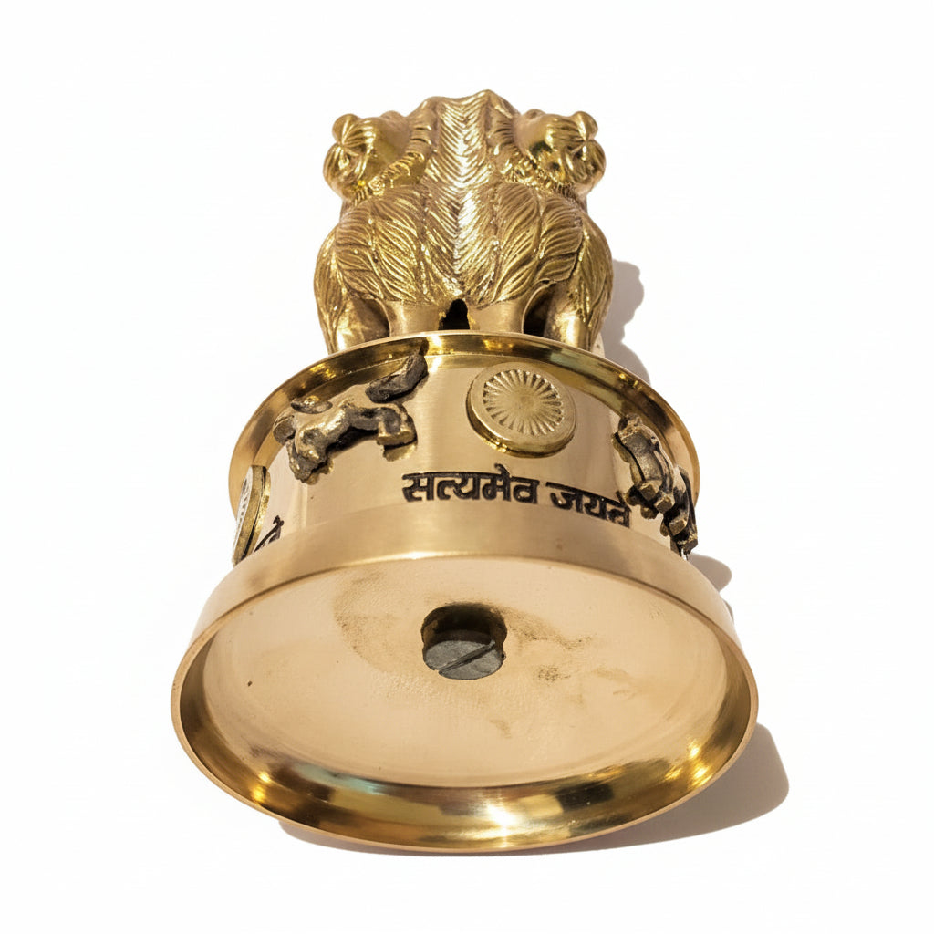 Gold bell with lion design on a white background
