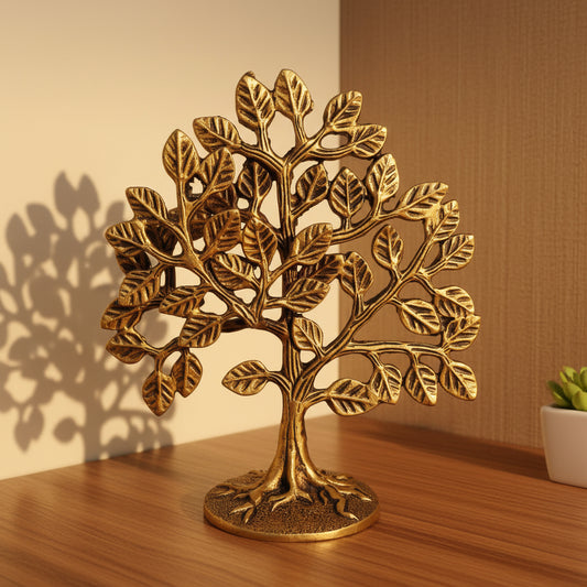 Decorative brass tree on a wooden surface with a white background
