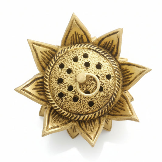 Decorative gold object with intricate design on a reflective surface