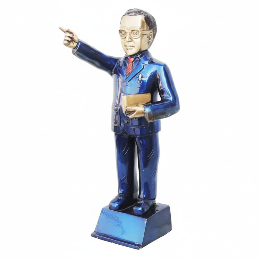 Statue of a person in a blue suit pointing forward on a white background