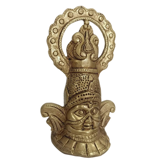Bronze statue of a face with intricate detailing on a white background