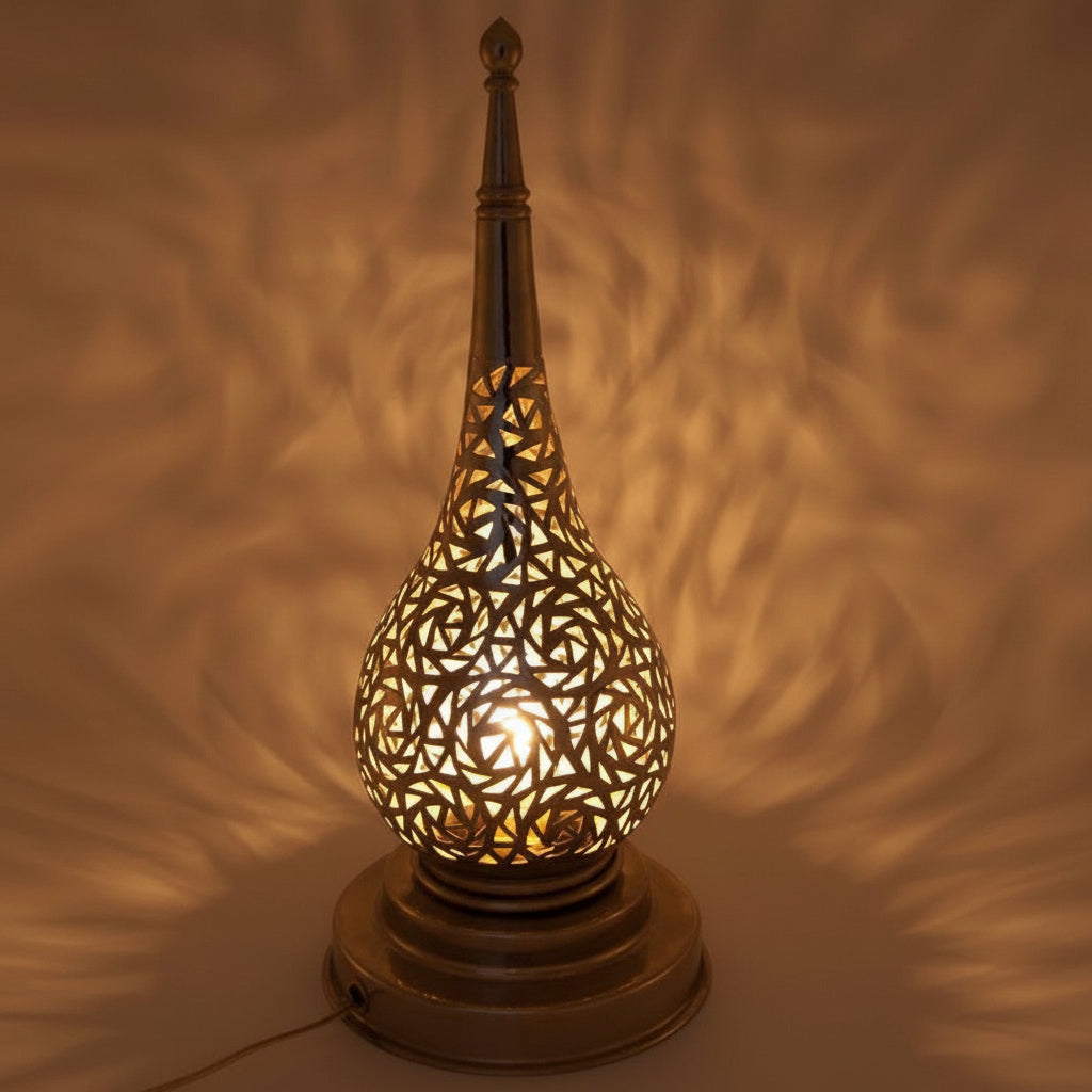 Decorative lamp with intricate cut-out design on a textured background
