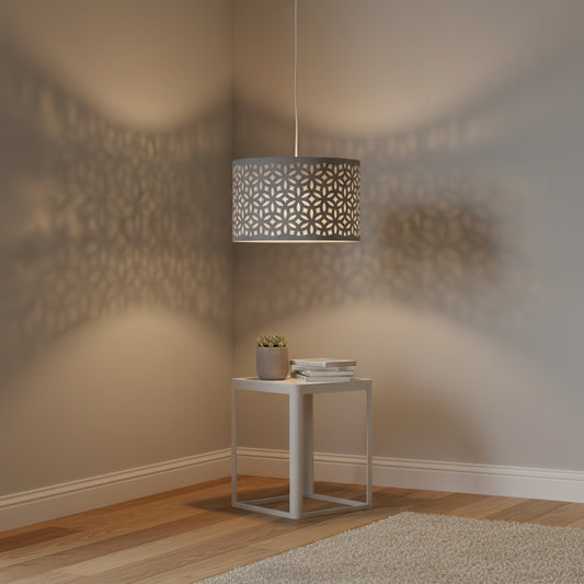Pendant light casting shadows on a wall in a room with a small table and decor items.