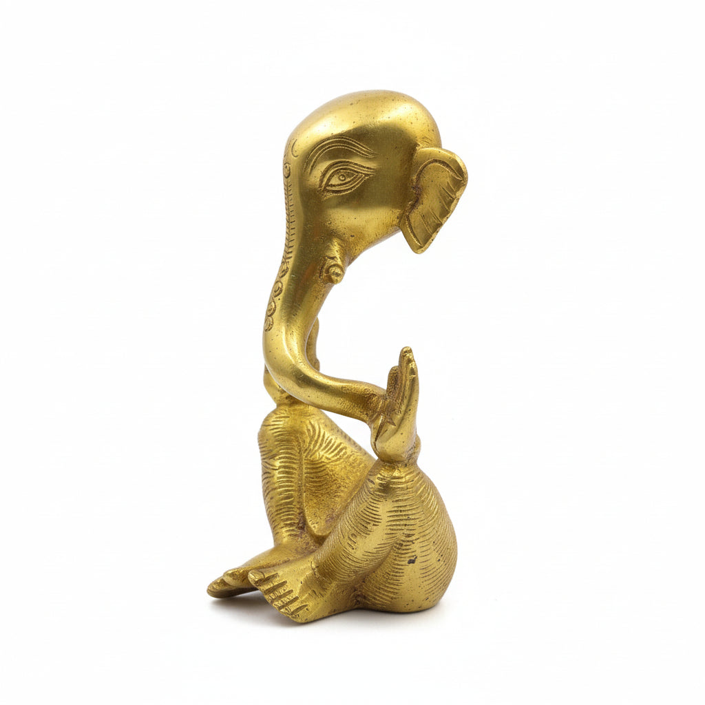 Gold-colored elephant statue on a white background