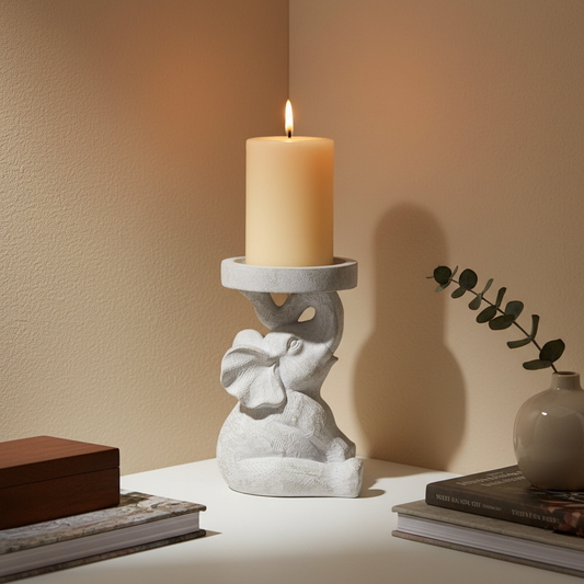 Decorative candle holder elephant shaped a with a lit candle on a beige background