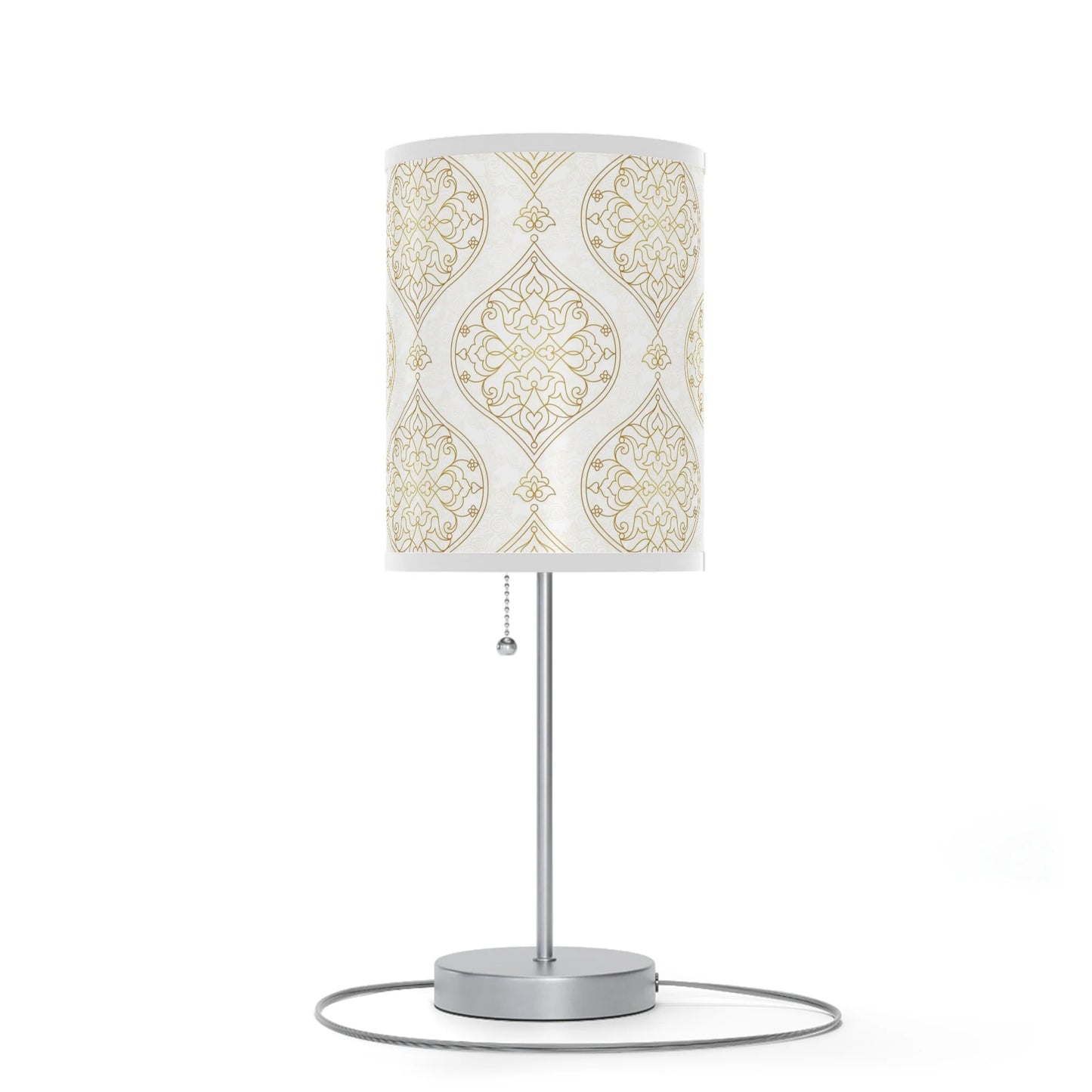 Table lamp with decorative white and gold patterned shade on a white background