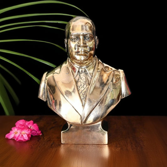 Silver bust of a man on a wooden surface with a dark background