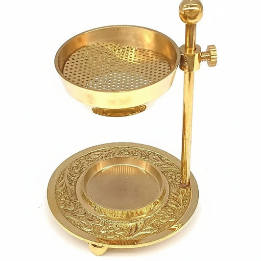 Gold-colored metal stand with perforated top and decorative base on a white background