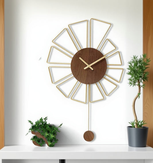 Decorative wall clock with wooden face and gold metal accents on a white wall.