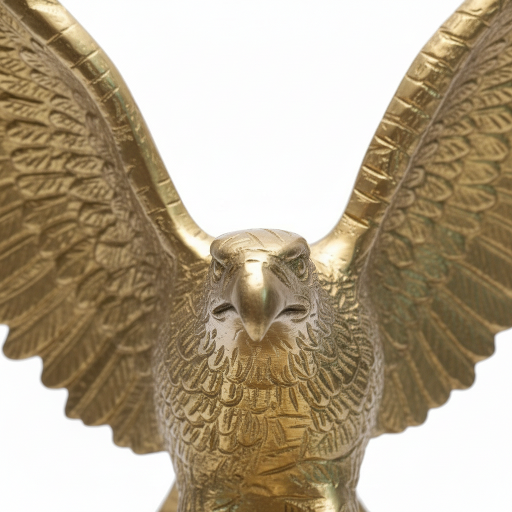 Gold eagle statue with open wings on a white background