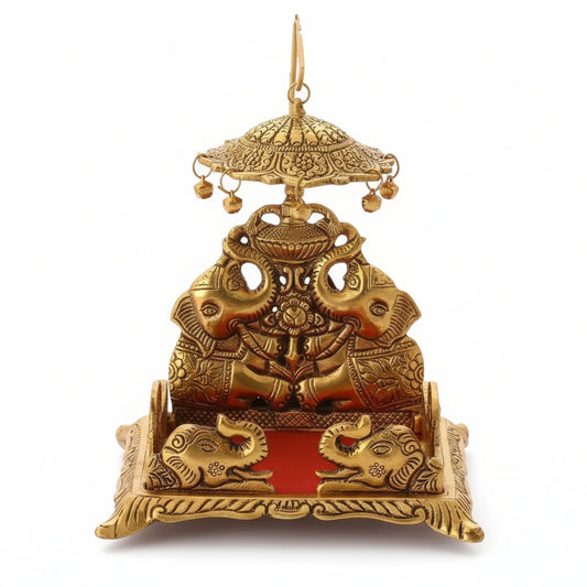 Decorative brass figure with intricate designs on a wooden surface