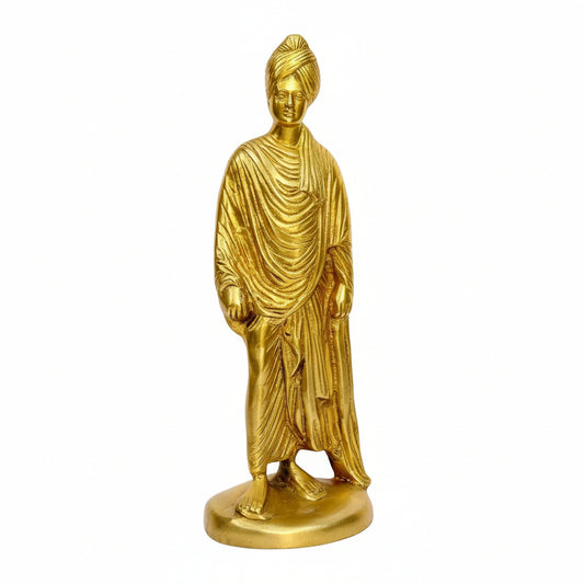 Gold-colored statue of a standing figure on a white background