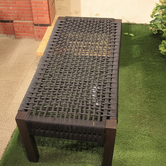 Woven bench with wooden frame on grass