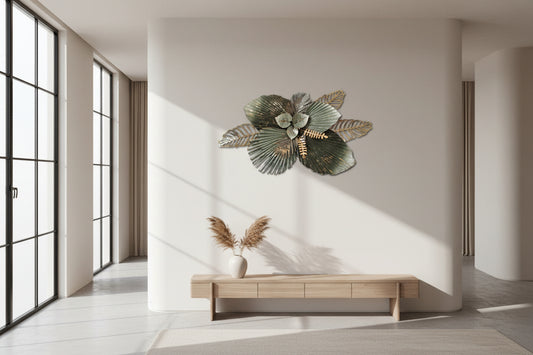 Decorative metal wall art with leaf designs on a beige background