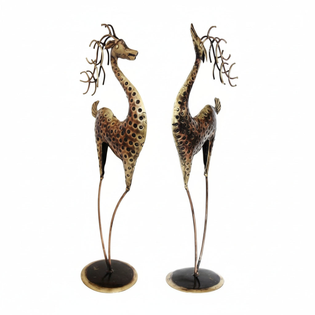 Two decorative giraffe statues on a white background