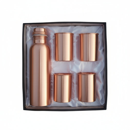 Copper bottle and four cups set in a box on a white background