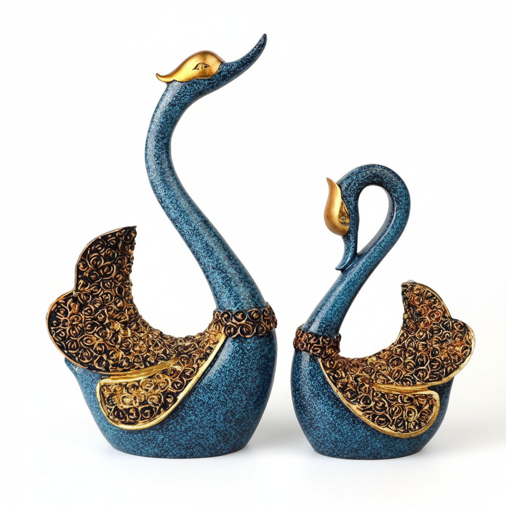 Decorative swan statues with intricate designs on a white background