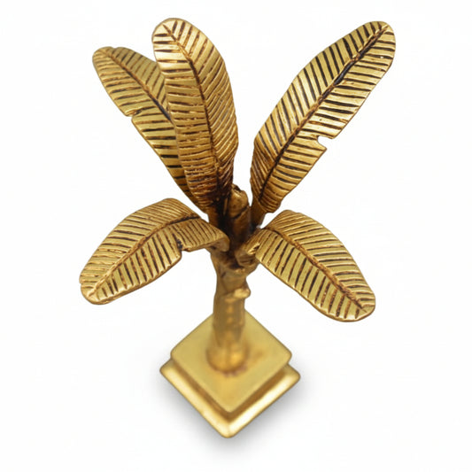 Gold palm tree decorative item on a white background
