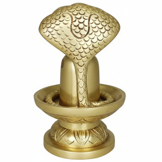 Decorative gold object with intricate design on a white background