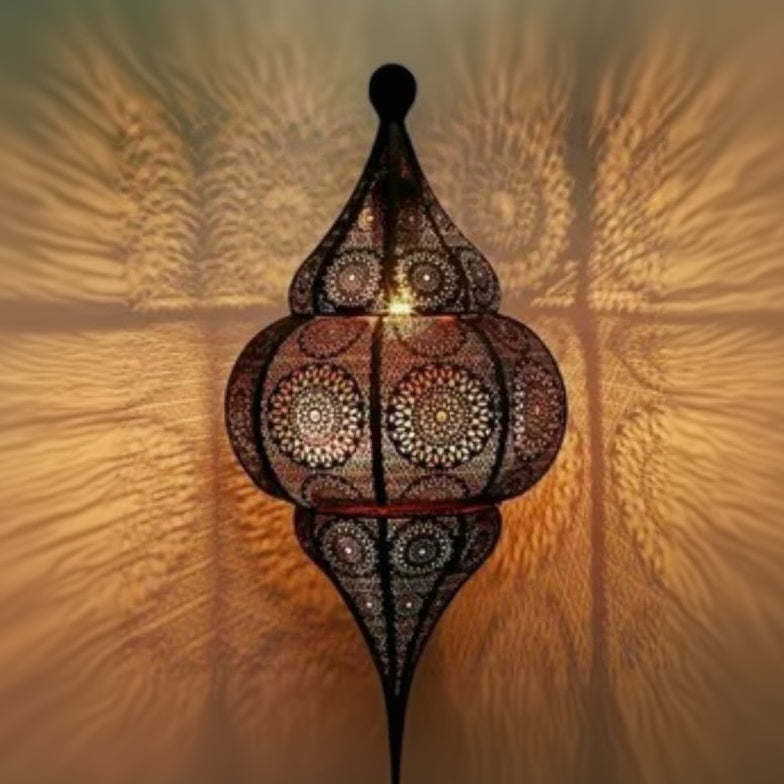 Decorative hanging lamp with intricate patterns on a textured wall background