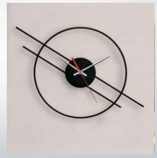 Modern wall clock with black and red design on a light gray background