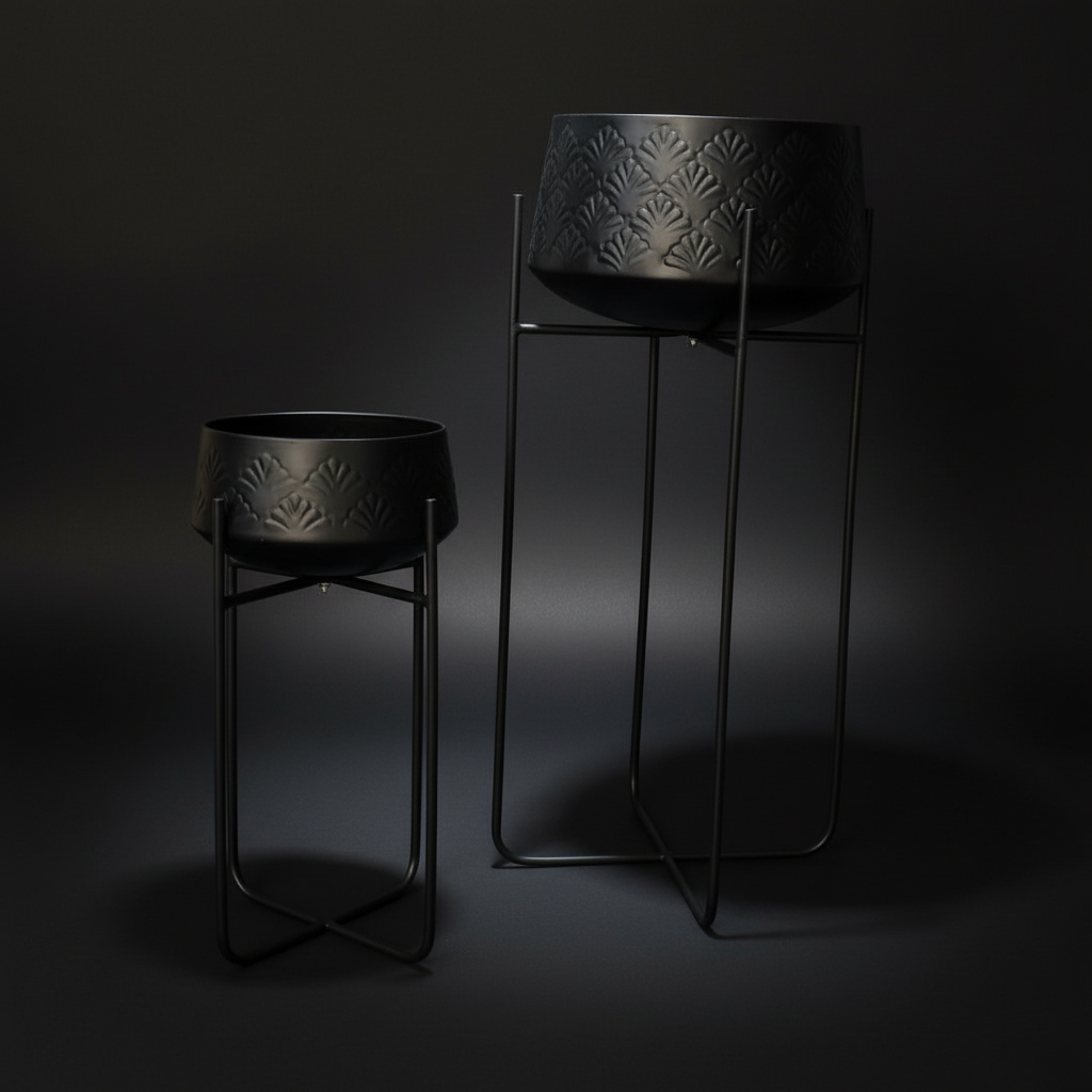 Two black decorative planters with geometric patterns on a dark background