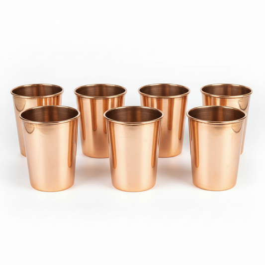 Set of eight copper cups on a white background