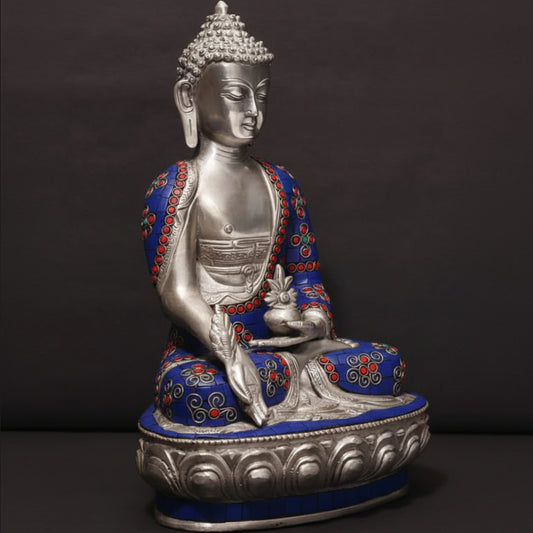 Buddha statue with blue and red accents on a dark background