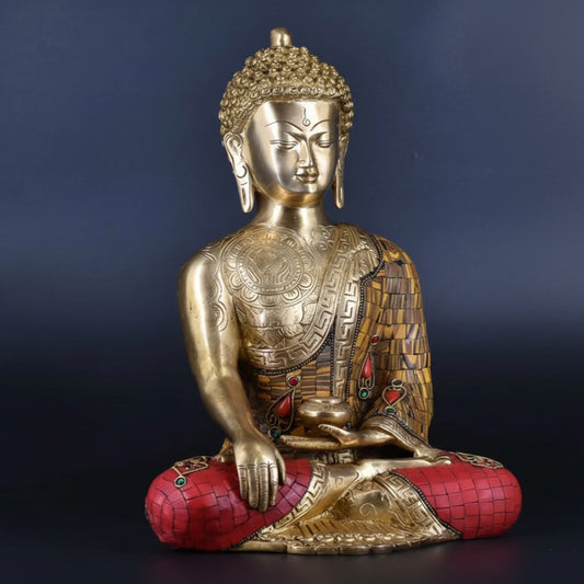 Gold Buddha statue with red base on a dark blue background