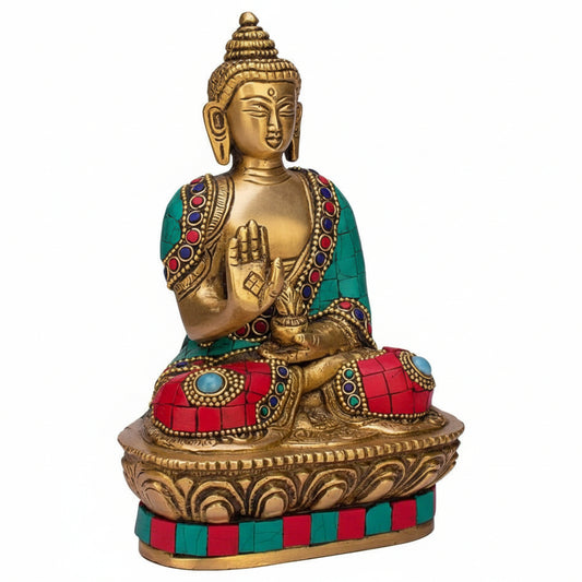 Decorative statue of a seated figure with colorful gemstones on a white background