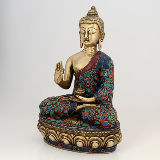 Decorative statue of a seated figure with colorful attire on a white background