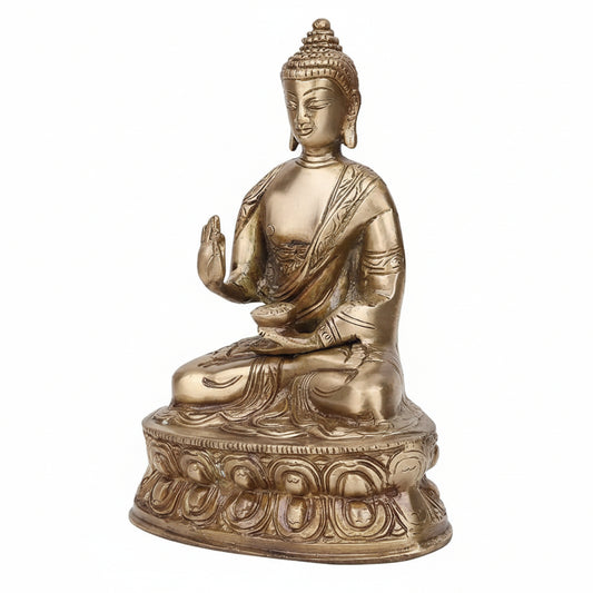 Bronze statue of a seated Buddha on a white background