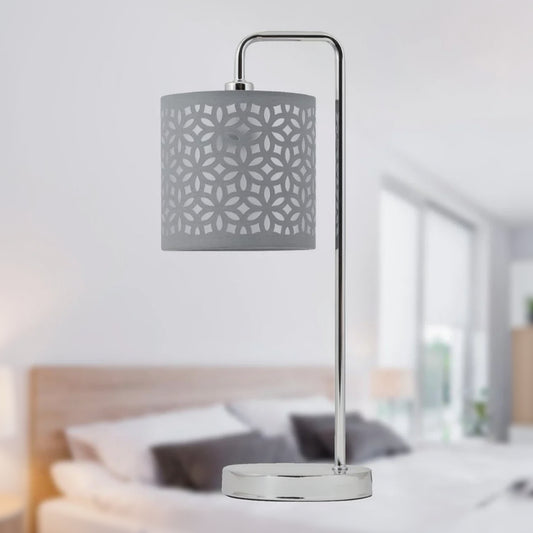 Table lamp with decorative gray shade in a bedroom setting