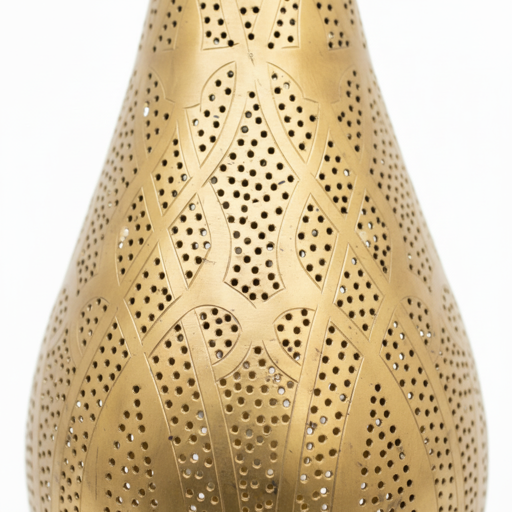 Gold decorative table lamp with intricate design on a white background