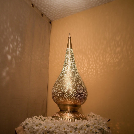 Decorative lamp with intricate design on a textured surface