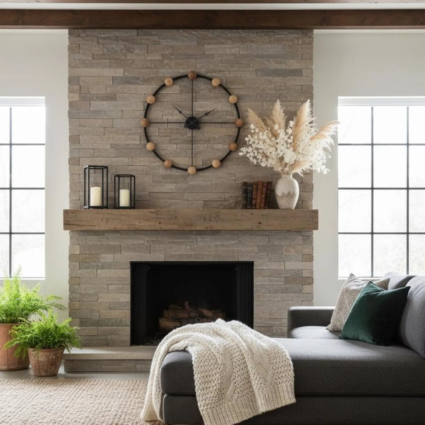 Living room with stone fireplace, gray sofa, and decorative elements.