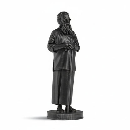 Statue of a bearded figure in robes on a gray background
