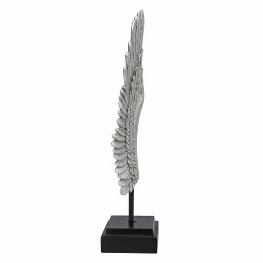 Decorative feather sculpture on a black base against a white background
