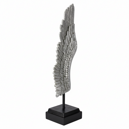 Decorative sculpture of a wing on a stand with a white background