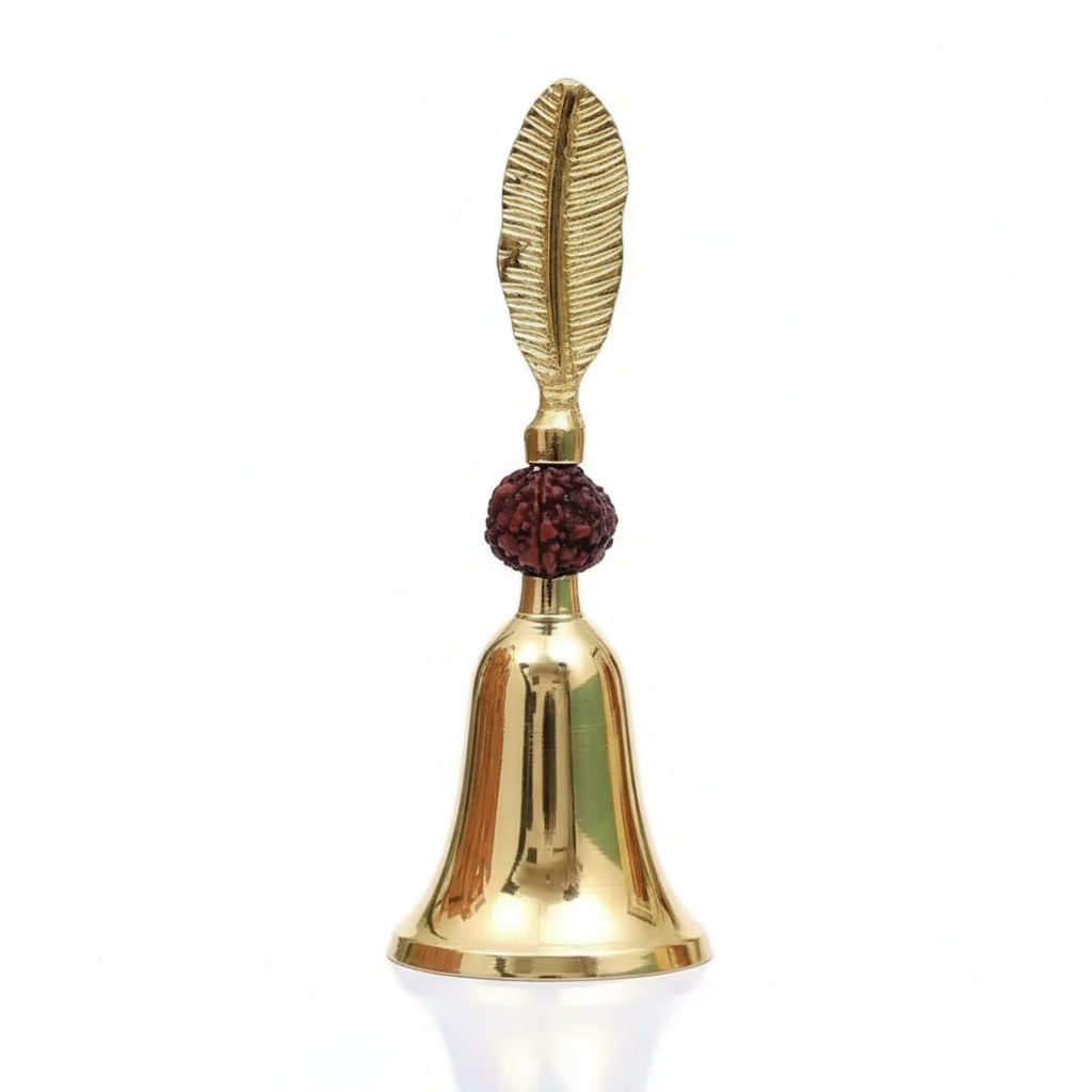 Gold bell with a feather and red bead on a white background