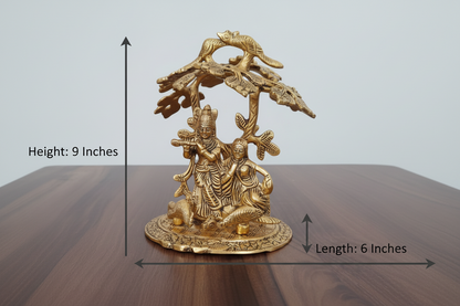 Gold-colored statue with measurements on a wooden surface